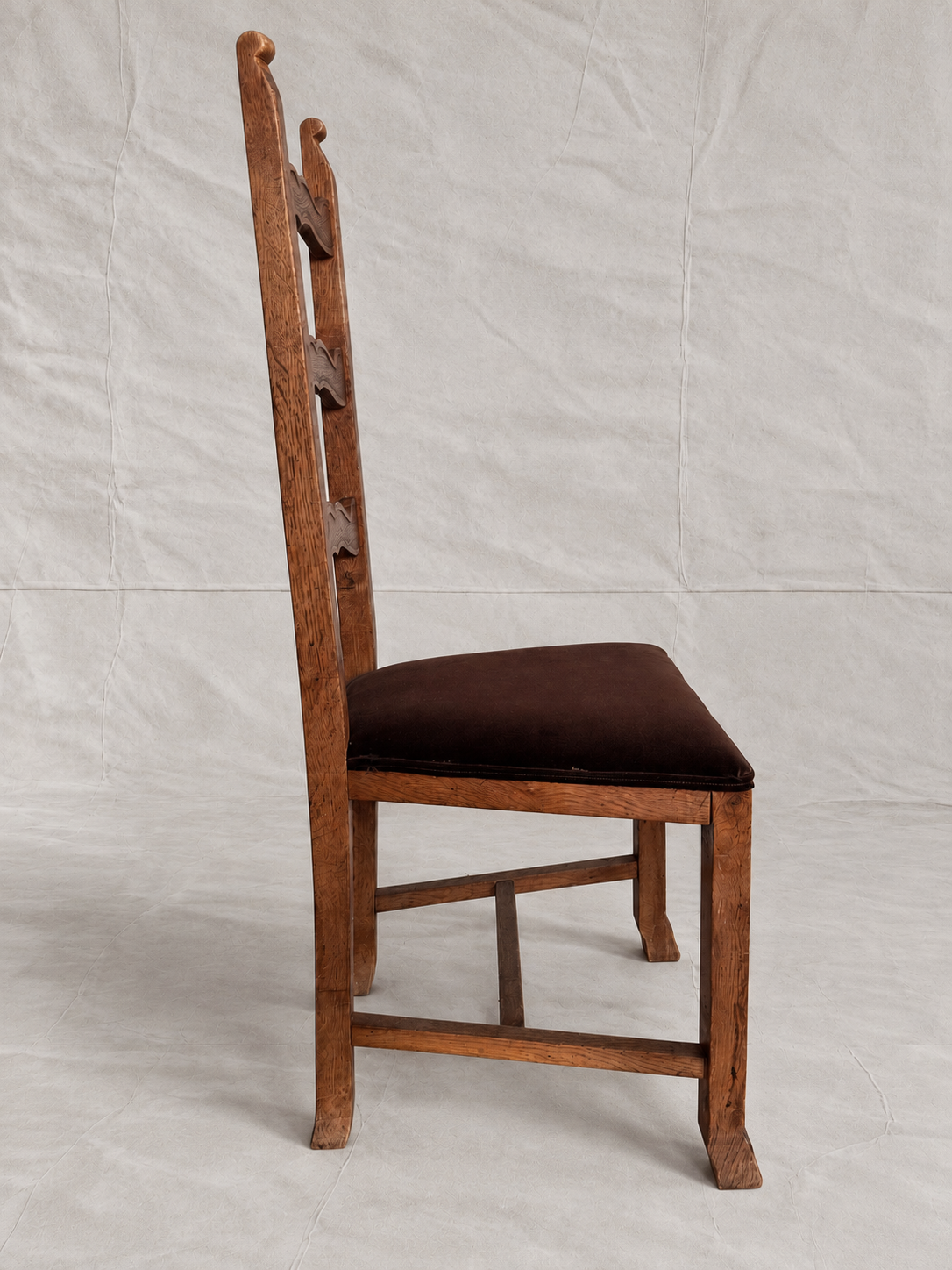 Skønvirke-style carved oak dining chairs with Rose Uniacke brown cotton velvet seats in Logwood