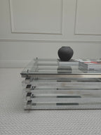 Italian chrome and glass stacked coffee table - full table shown from the front in a room