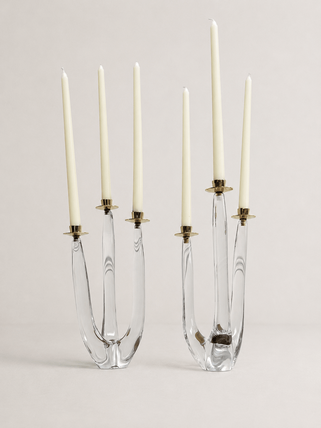 Pair of mid-century sculptural clear glass three-arm candelabras