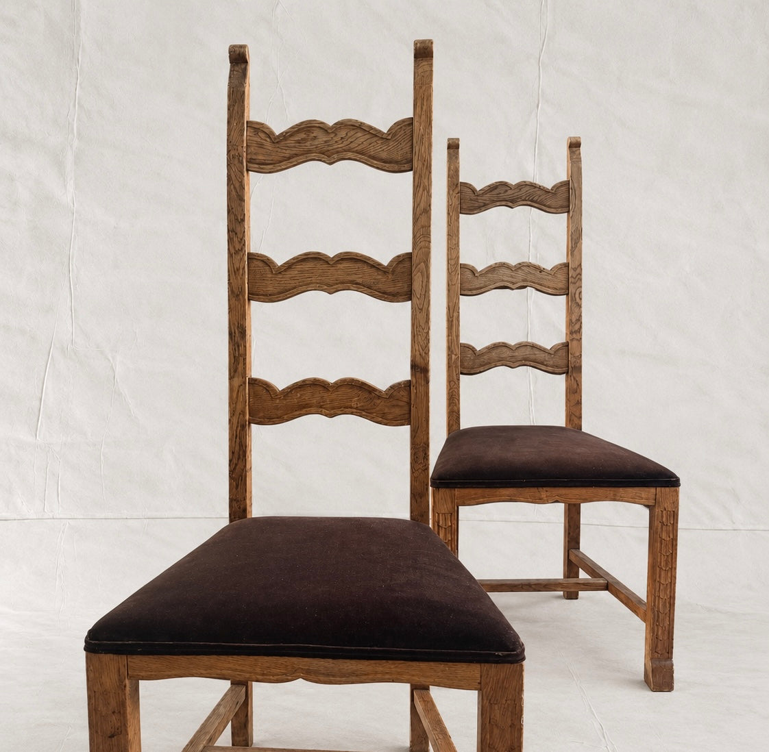 Skønvirke-style carved oak dining chairs with Rose Uniacke brown cotton velvet seats in Logwood