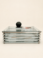 Italian chrome and glass stacked coffee table - styled front view in the studio