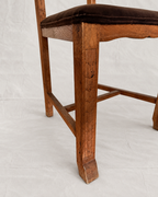 Skønvirke-style carved oak dining chairs with Rose Uniacke brown cotton velvet seats in Logwood