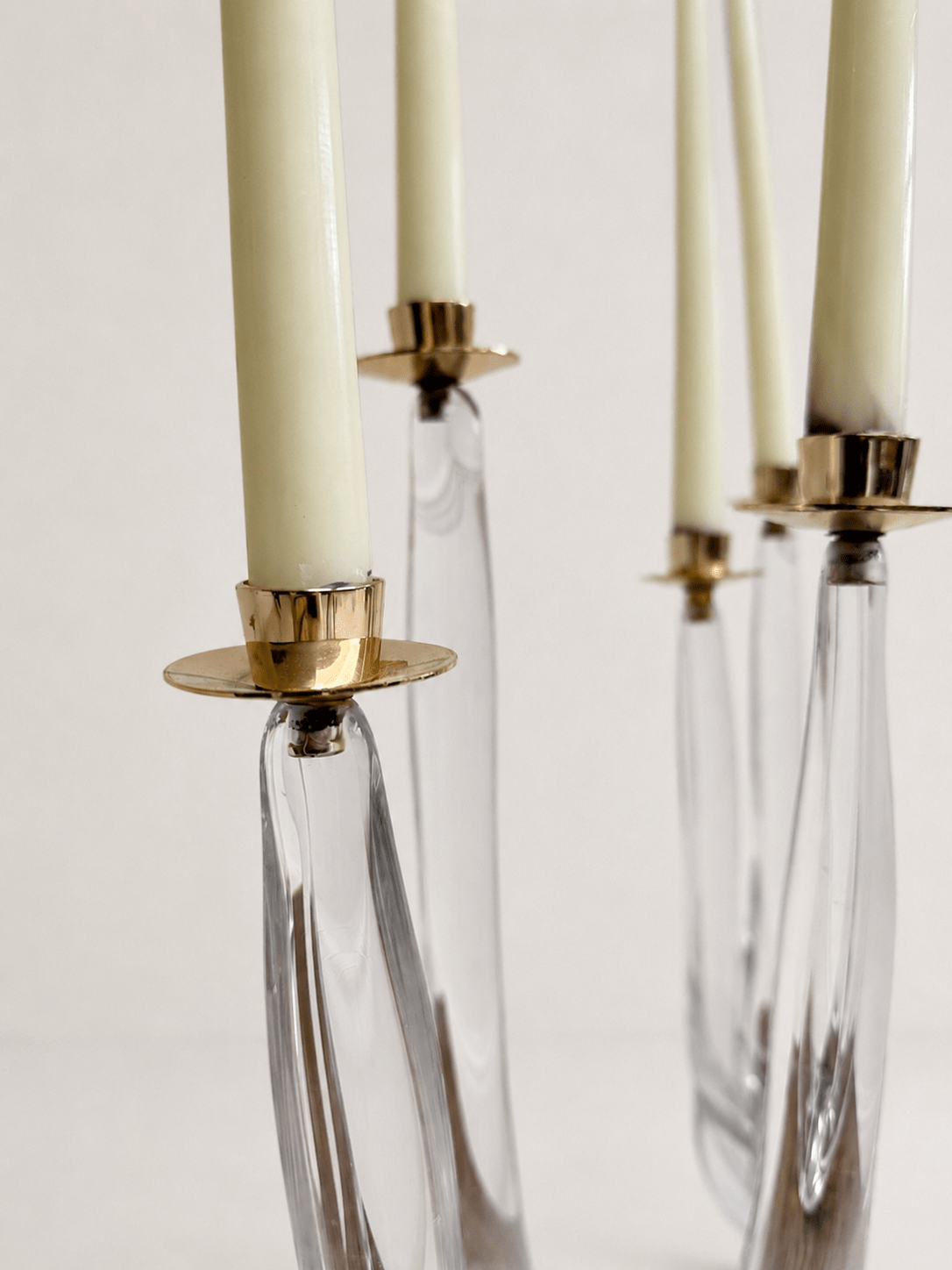 Pair of mid-century sculptural clear glass three-arm candelabras