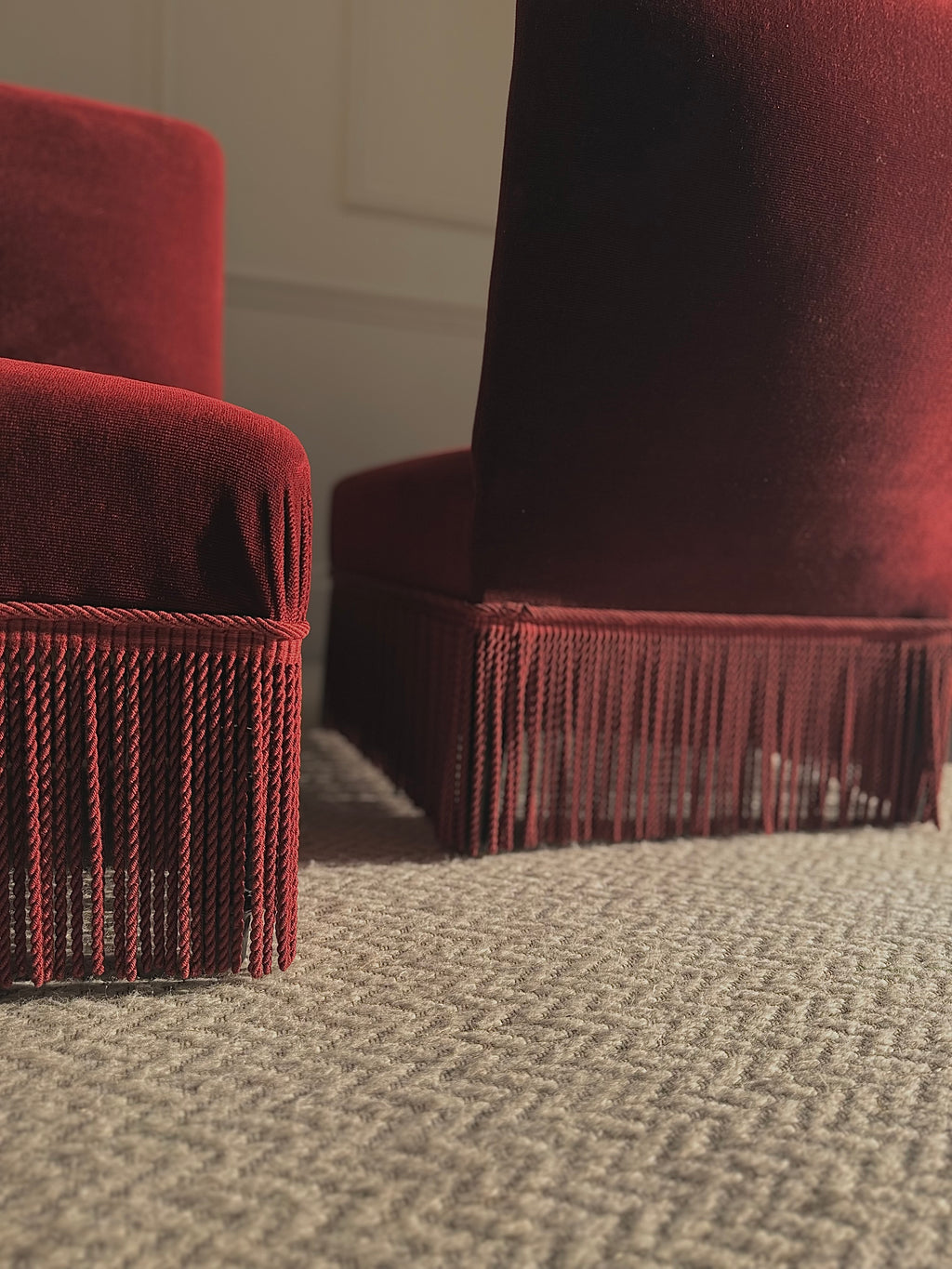 A pair of French Napoleon III red velvet slipper chairs with fringe