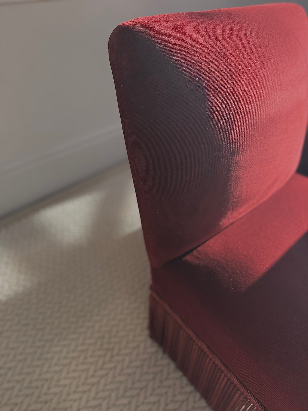 A pair of French Napoleon III red velvet slipper chairs with fringe