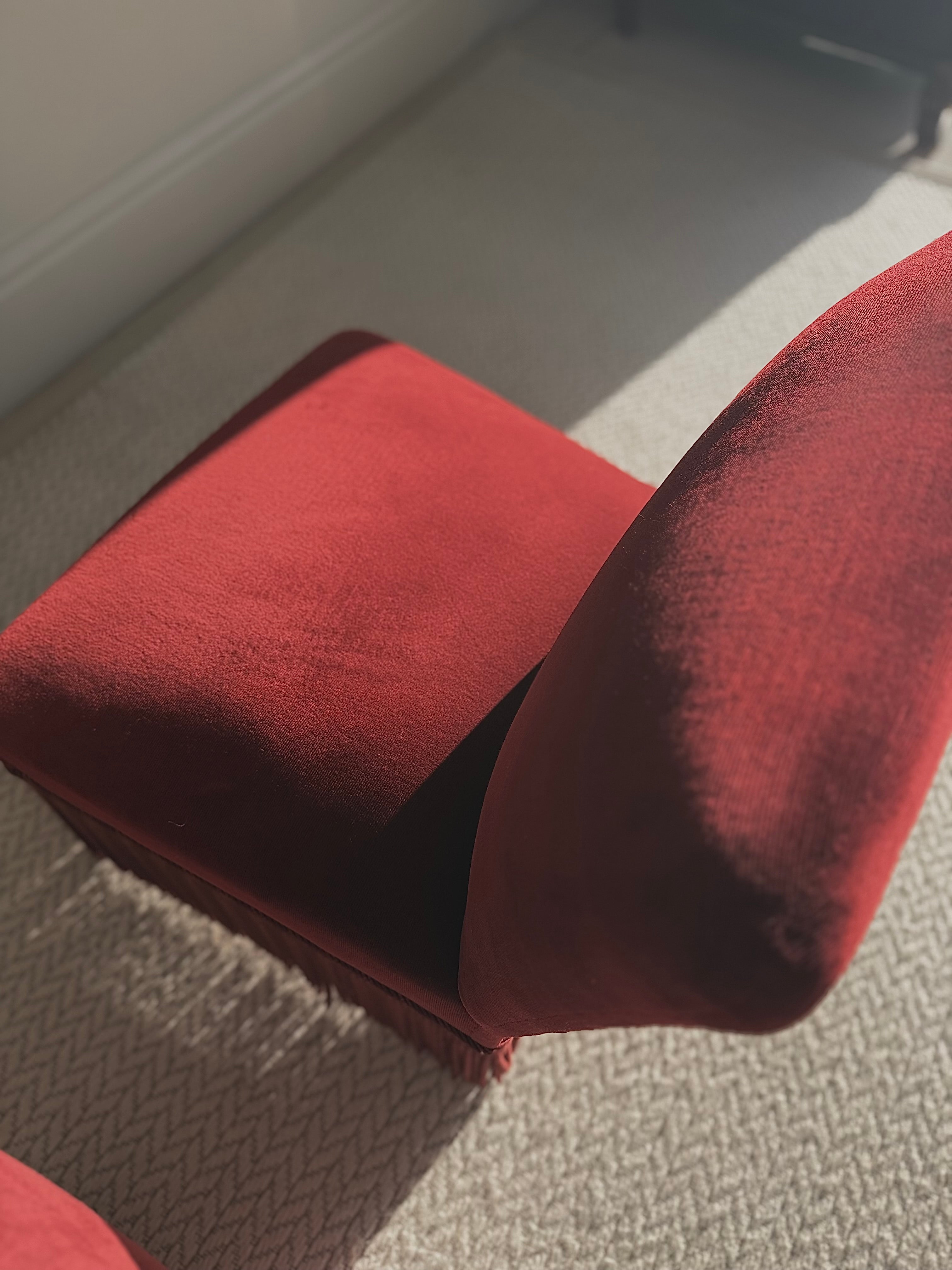 A pair of French Napoleon III red velvet slipper chairs with fringe