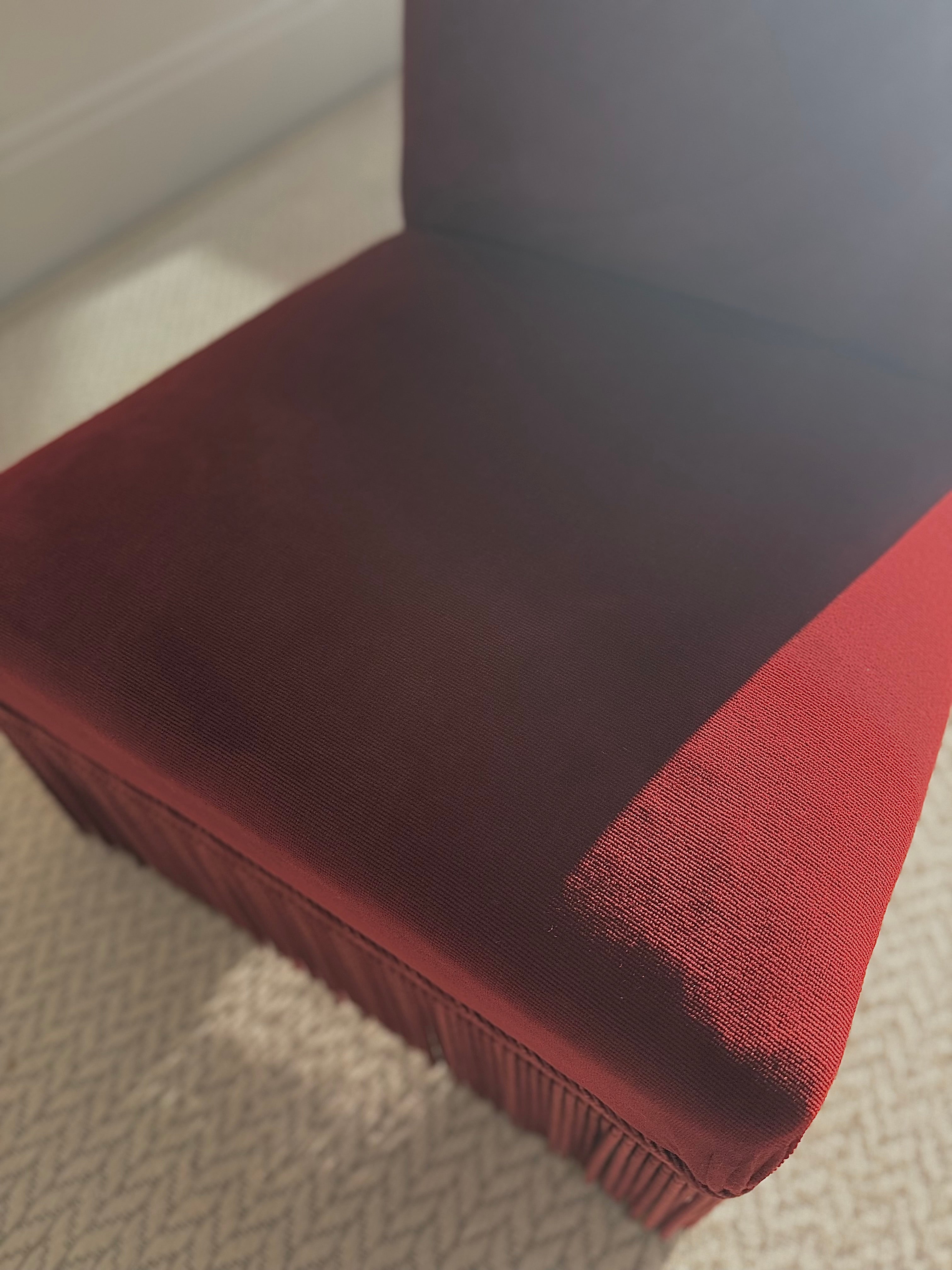 A pair of French Napoleon III red velvet slipper chairs with fringe
