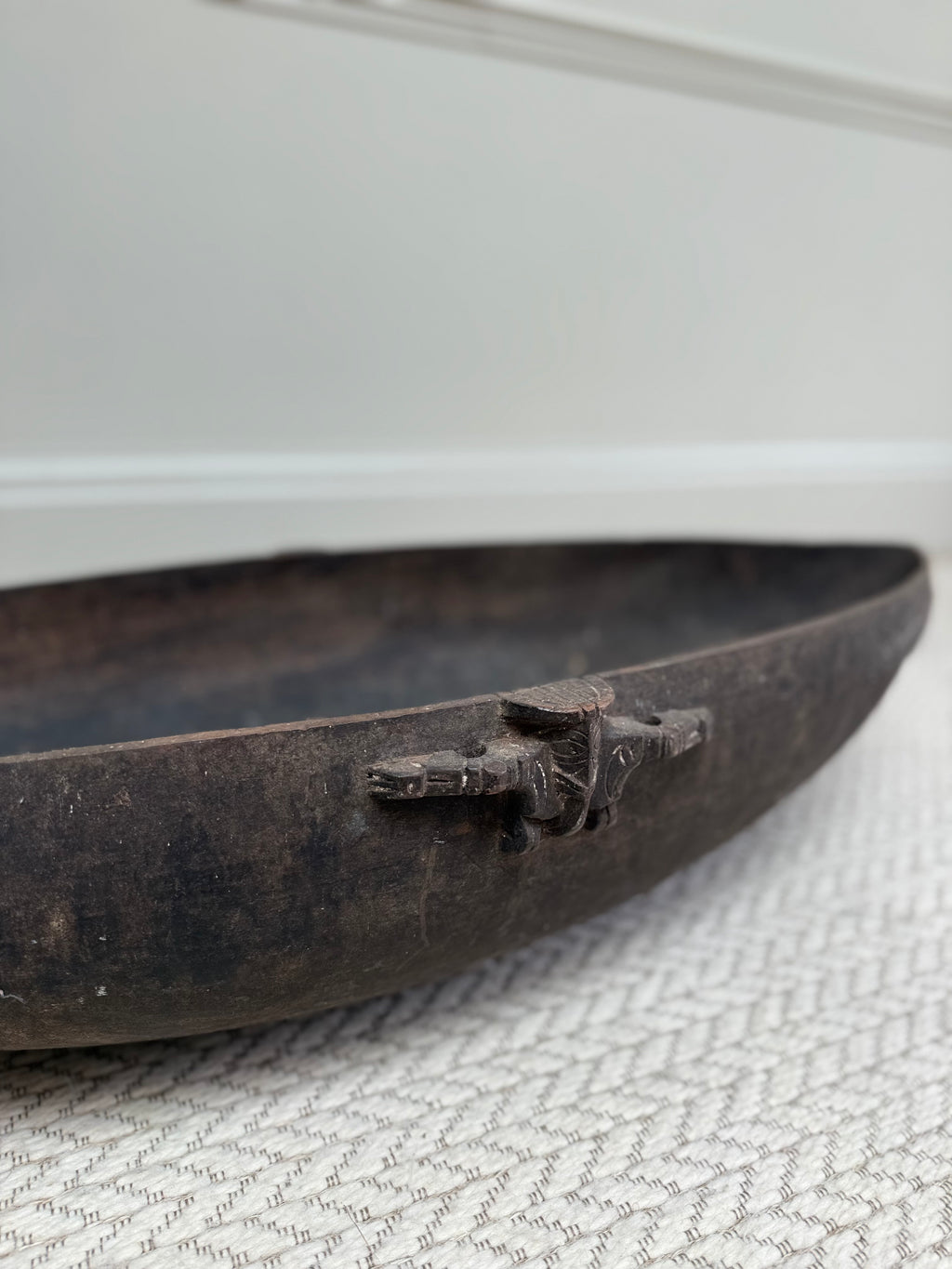 Profile view of an early 20th century primitive wooden feasting bowl