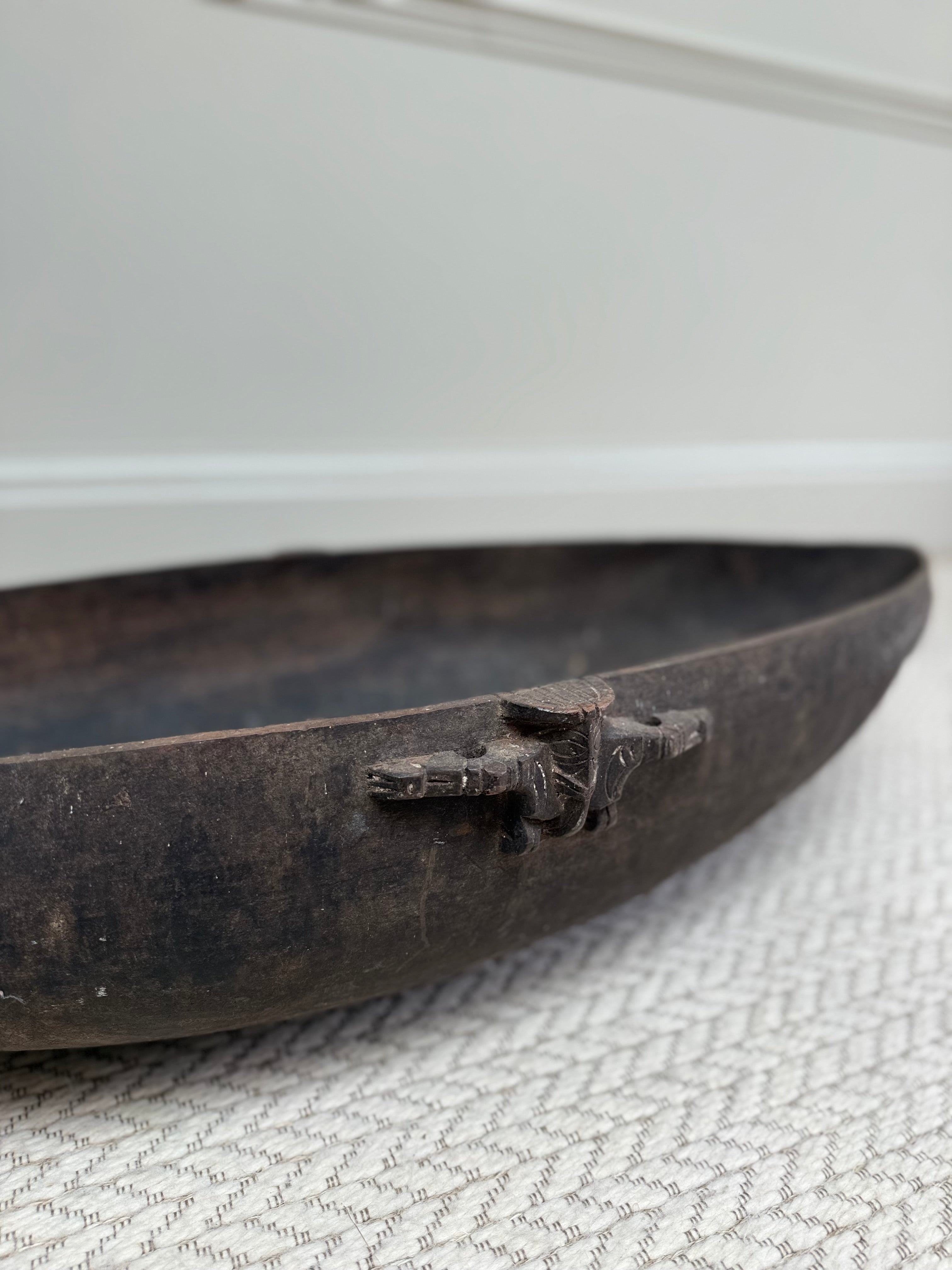 Profile view of an early 20th century primitive wooden feasting bowl