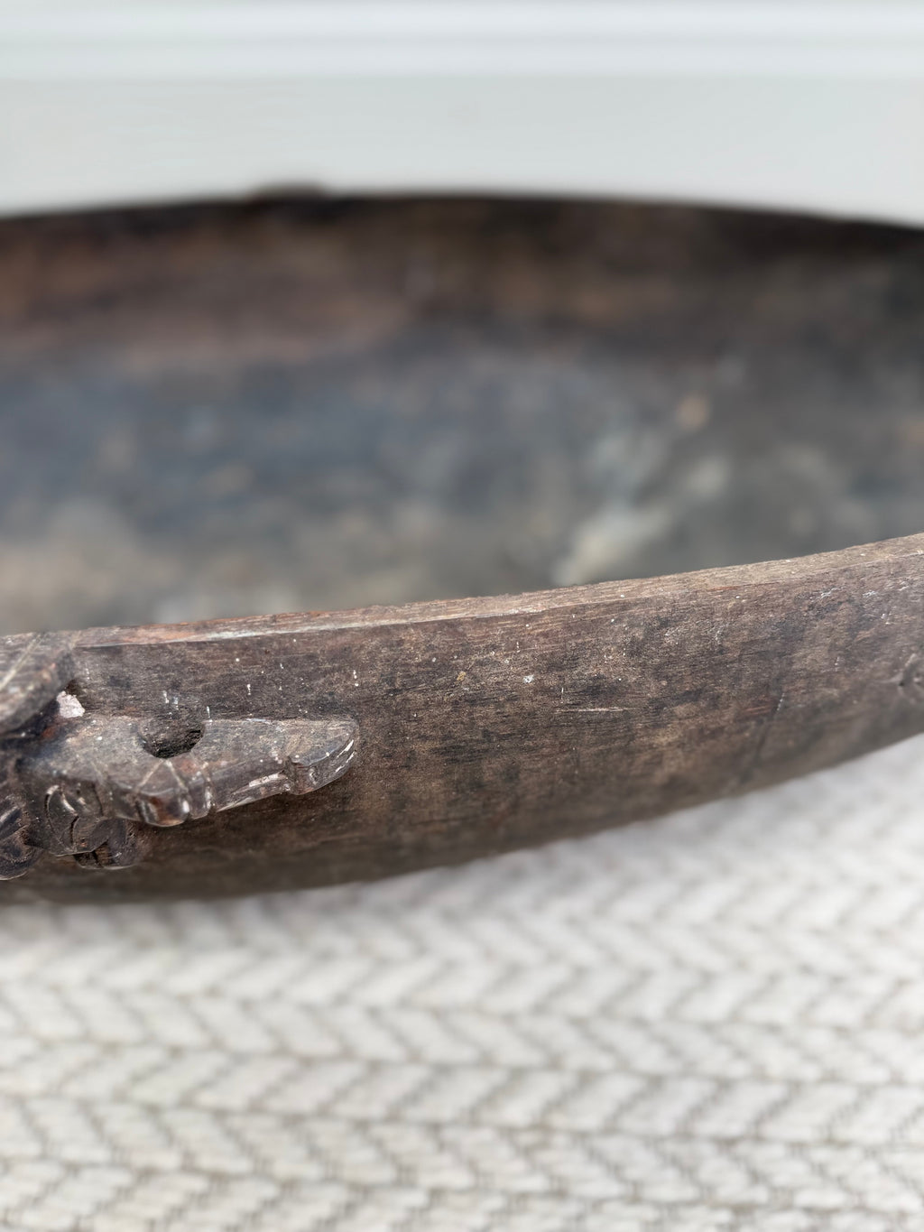 Close-up of the aged timber and patina on an early 20th century wooden feasting bowl