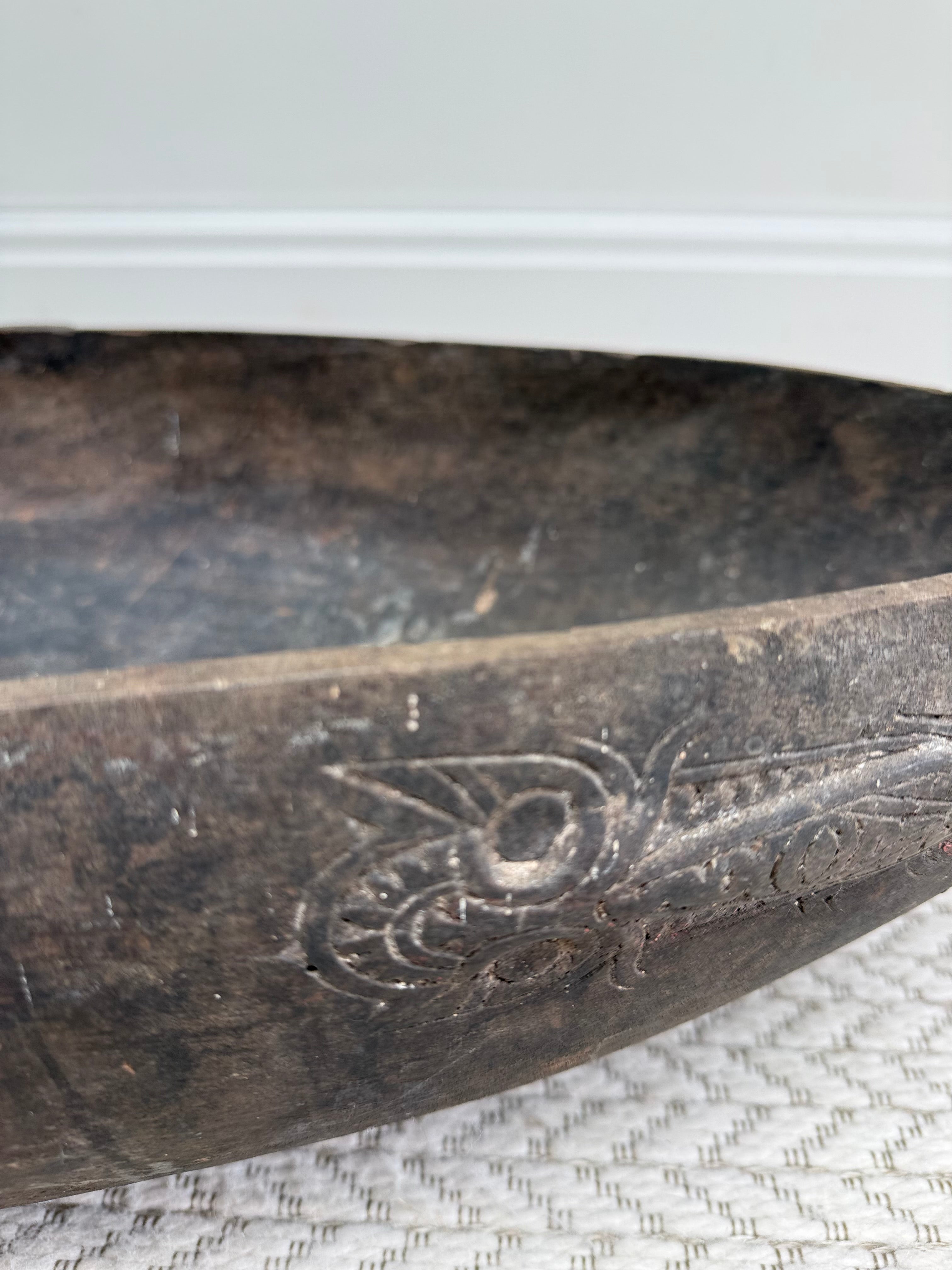 Side view of an early 20th century wooden feasting bowl
