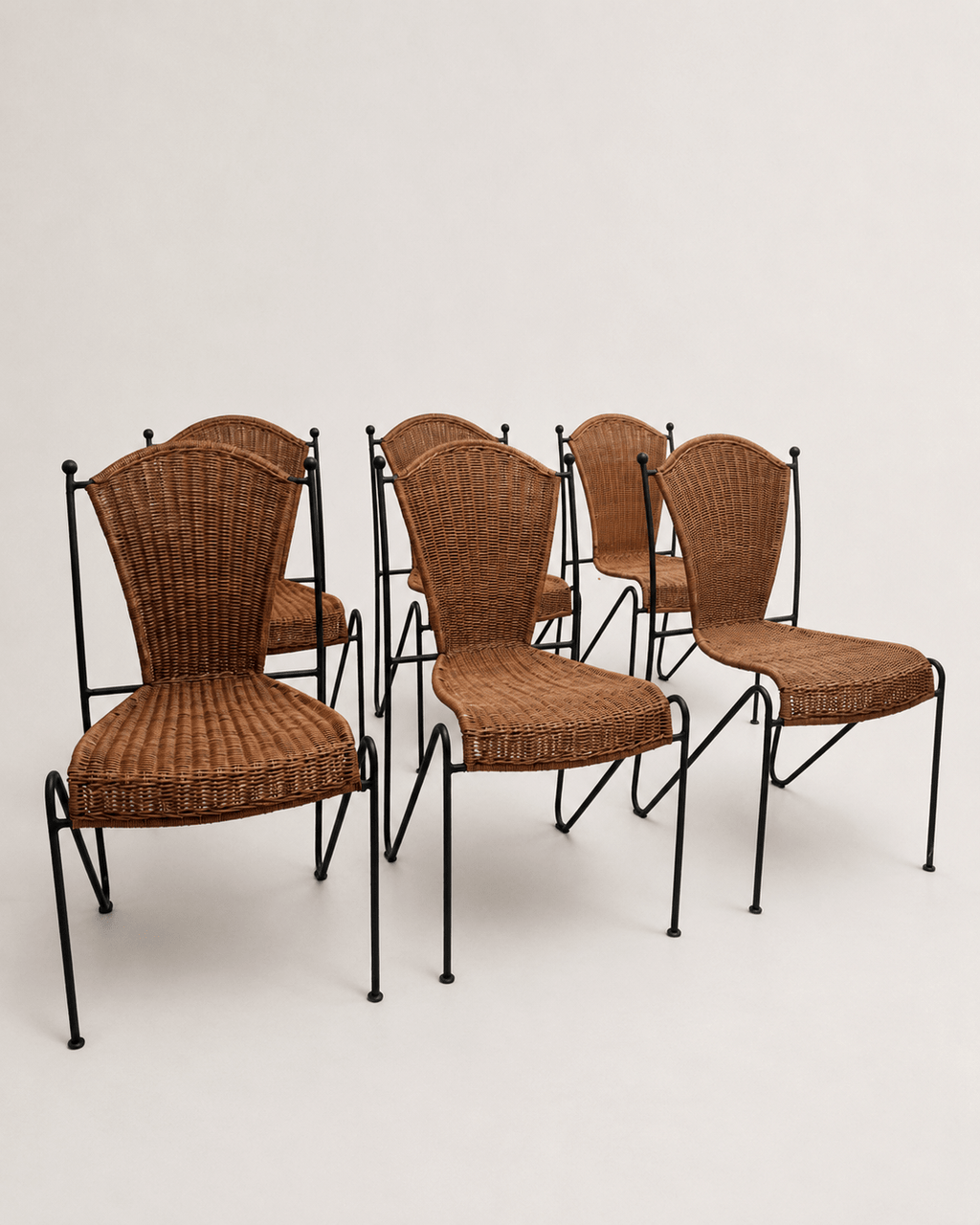 mid-century wicker and iron dining chairs - set grouped from the front