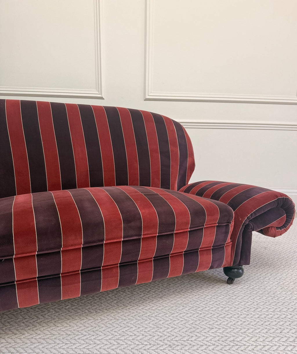 striped velvet curved-back two-seater sofa - front view in a styled interior