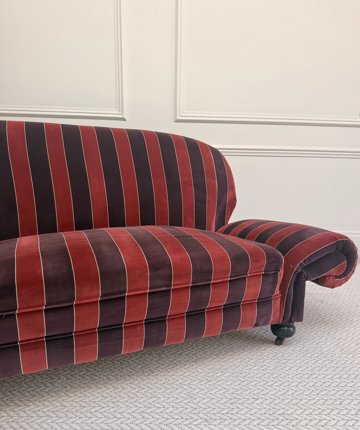 striped velvet curved-back two-seater sofa - front view in a styled interior